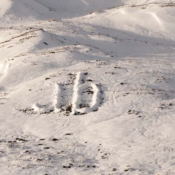 Melt by Michael Cross. Giant letters acb made of smow on a hillside.